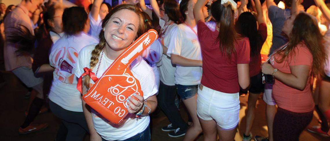 Student with foam finger at Trax